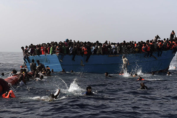 AFP PICTURES OF THE YEAR 2016Migrants wait to be rescued by members of Proactiva Open Arms NGO in the Mediterranean Sea, some 12 nautical miles north of Libya, on October 4, 2016.At least 1,800 migrants were rescued off the Libyan coast, the Italian coastguard announced, adding that similar operations were underway around 15 other overloaded vessels. / AFP PHOTO / ARIS MESSINIS